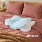 Sleepsake Butterfly Pillow on a made bed with dusty-rose linen