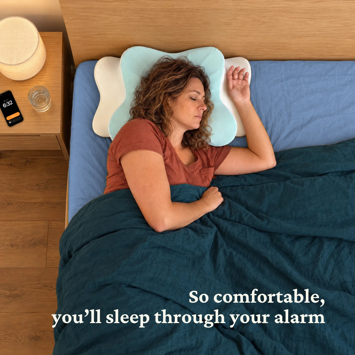 Woman sleeping on through her phone alarm on the Sleepsake Butterfly Pillow: so comfortable, you'll sleep through your alarm